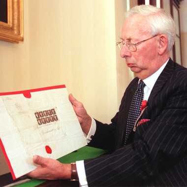 Charles Goodwyn, Keeper of the Royal Philatelic Collection, with copies of world’s first stamp