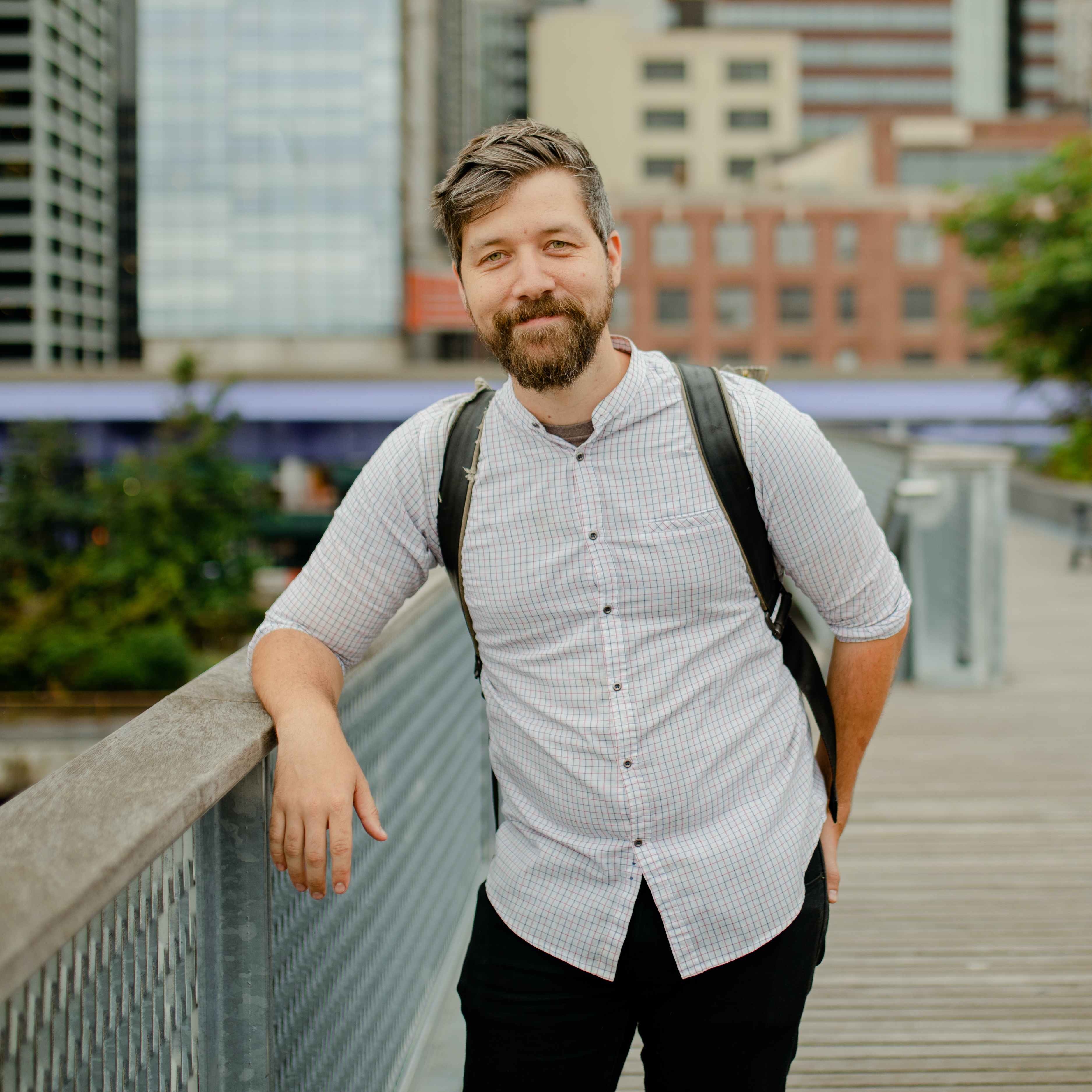 Dylan Thuras standing on a boardwalk leaning on a rail